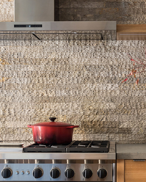 craftline cream stone tile used on a kitchen backsplash.